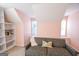 Cozy bedroom featuring soft pink walls, plush carpeting, and a comfortable sofa at 155 Cottage Cir, Fayetteville, GA 30215