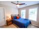 Inviting bedroom featuring a wood-frame bed, nightstand, and modern ceiling fan at 155 Cottage Cir, Fayetteville, GA 30215