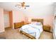 Comfortable bedroom with carpeting, dresser, and a wood-frame bed with blue comforter at 155 Cottage Cir, Fayetteville, GA 30215