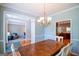Charming dining room with hardwood floors, wooden table, and views into the living room and kitchen at 155 Cottage Cir, Fayetteville, GA 30215