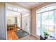 Inviting foyer with hardwood floors, a white front door, and views into the adjacent dining room at 155 Cottage Cir, Fayetteville, GA 30215