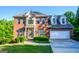 Charming two-story brick home featuring a well-manicured lawn and attached two car garage at 155 Cottage Cir, Fayetteville, GA 30215