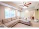 Inviting living room with a large sectional sofa, plush carpeting, recessed lighting, and access to the backyard at 155 Cottage Cir, Fayetteville, GA 30215
