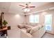 Spacious living room with a large sectional sofa, plush carpeting, recessed lighting and backyard access at 155 Cottage Cir, Fayetteville, GA 30215