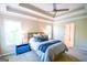 Spacious main bedroom with tray ceilings, carpeted floor, and abundant natural light streaming through the windows at 155 Cottage Cir, Fayetteville, GA 30215