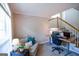Cozy office space with couch, wooden desk, and staircase access, bathed in natural light at 155 Cottage Cir, Fayetteville, GA 30215