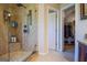 Modern bathroom shower with glass door and tiled walls is accented by an open door to a walk-in closet at 155 Cottage Cir, Fayetteville, GA 30215