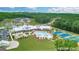 An aerial view of the community clubhouse featuring a pool, tennis courts, and parking areas at 500 Cottonwood Cir, Peachtree City, GA 30269