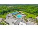 Stunning aerial view of community amenities including tennis courts, pool, and clubhouse surrounded by lush greenery at 500 Cottonwood Cir, Peachtree City, GA 30269