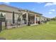Large, grassy backyard with a covered patio area, perfect for outdoor activities at 500 Cottonwood Cir, Peachtree City, GA 30269