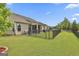 A fenced-in backyard with a stone path that leads to a covered patio with an outdoor kitchen at 500 Cottonwood Cir, Peachtree City, GA 30269