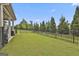 Spacious backyard with a well-maintained lawn and a secure black metal fence at 500 Cottonwood Cir, Peachtree City, GA 30269