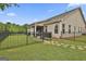 Fenced-in backyard view featuring a stone pathway leading to a covered outdoor seating area at 500 Cottonwood Cir, Peachtree City, GA 30269