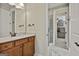 Bathroom featuring wood vanity, stone countertop, and glass enclosed walk in shower at 500 Cottonwood Cir, Peachtree City, GA 30269