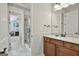 Modern bathroom with a glass-enclosed shower, tiled floor, and wooden cabinets at 500 Cottonwood Cir, Peachtree City, GA 30269