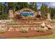 Stone entrance with manicured landscaping and the 'Cresswind' sign creates a welcoming first impression at 500 Cottonwood Cir, Peachtree City, GA 30269