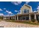 An exterior elevation of the community clubhouse, offering multiple seating areas at 500 Cottonwood Cir, Peachtree City, GA 30269