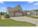 A well-maintained single Gathering home with a two-car garage, lush lawn, and brick facade at 500 Cottonwood Cir, Peachtree City, GA 30269