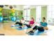 Well-lit fitness center with exercise equipment, mats, and fitness balls for residents' use at 500 Cottonwood Cir, Peachtree City, GA 30269