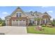 Charming home featuring a well-maintained lawn, a two-car garage, and eye-catching brick and siding accents at 500 Cottonwood Cir, Peachtree City, GA 30269