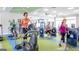 View of a community gym with a variety of exercise machines, televisions, and workout equipment at 500 Cottonwood Cir, Peachtree City, GA 30269