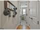 Hallway leading to laundry room with coat rack, mirror and wood floors at 500 Cottonwood Cir, Peachtree City, GA 30269