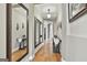 Hallway offers hardwood floors, neutral paint, and 3 decorative mirrors at 500 Cottonwood Cir, Peachtree City, GA 30269