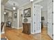Hallway offers three decorative mirrors, hardwood floors, and neutral wall color at 500 Cottonwood Cir, Peachtree City, GA 30269