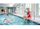 Indoor pool featuring swimmers, ample natural light, and easy access to locker rooms at 500 Cottonwood Cir, Peachtree City, GA 30269