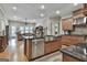 Open kitchen boasts stainless steel appliances, granite countertops, and hardwood floors at 500 Cottonwood Cir, Peachtree City, GA 30269