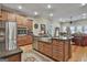 Well-lit kitchen features a stainless steel farmhouse sink, granite countertops, and hardwood floors at 500 Cottonwood Cir, Peachtree City, GA 30269