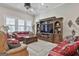 Comfortable living room featuring hardwood floors, built-in entertainment center, and bright windows at 500 Cottonwood Cir, Peachtree City, GA 30269