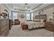 Spacious main bedroom features neutral decor, a tray ceiling, and an upholstered bed frame at 500 Cottonwood Cir, Peachtree City, GA 30269