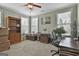 Home office area featuring large windows and wooden desk and shelving at 500 Cottonwood Cir, Peachtree City, GA 30269