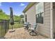 Charming outdoor patio with a small table set and beautiful brick flooring at 500 Cottonwood Cir, Peachtree City, GA 30269