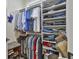 Organized walk-in closet with rods and shelves for clothing storage and organization at 500 Cottonwood Cir, Peachtree City, GA 30269