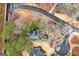 Aerial view of a property with meticulously maintained landscaping, mature trees, and a paved driveway at 600 Lake Overlook Dr, Canton, GA 30114