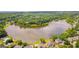 Expansive aerial view of a tranquil lake surrounded by lush greenery and upscale homes at 600 Lake Overlook Dr, Canton, GA 30114