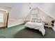 Attic bedroom with angled walls and a window, featuring a bed, an air conditioner, and side tables at 600 Lake Overlook Dr, Canton, GA 30114