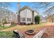 Backyard with a fire pit, hot tub, lush greenery, and a view of the home's exterior at 600 Lake Overlook Dr, Canton, GA 30114