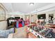 Basement area featuring a large TV, toys, stairs, and foosball table at 600 Lake Overlook Dr, Canton, GA 30114