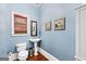 Charming powder room features pedestal sink, hardwood floors, and stylish decor at 600 Lake Overlook Dr, Canton, GA 30114