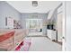 Well-lit bedroom features a window seat below a window, a bunk bed, and dresser with mirror at 600 Lake Overlook Dr, Canton, GA 30114