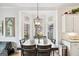 Dining area with chandelier features three large windows overlooking the backyard at 600 Lake Overlook Dr, Canton, GA 30114