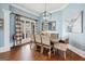 Elegant dining room featuring hardwood floors, soft blue walls, a chandelier and large windows at 600 Lake Overlook Dr, Canton, GA 30114