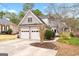 Attached two-car garage and driveway, with a well-maintained lawn, shrubbery and landscaping at 600 Lake Overlook Dr, Canton, GA 30114