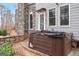 Close-up of a large hot tub on a concrete pad, nestled against the gray shingle siding at 600 Lake Overlook Dr, Canton, GA 30114