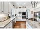 Modern kitchen with granite countertops, stainless steel appliances, and white cabinets at 600 Lake Overlook Dr, Canton, GA 30114