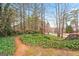 Path through lush ground cover leads to a landscaped backyard, showcasing the natural beauty of the property at 600 Lake Overlook Dr, Canton, GA 30114