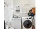 Convenient laundry room with modern washer and dryer, storage cabinets, and hanging rack at 600 Lake Overlook Dr, Canton, GA 30114